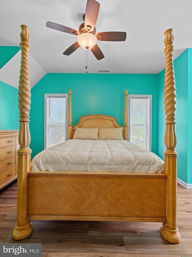bedroom featuring lofted ceiling, wood finished floors, and ceiling fan