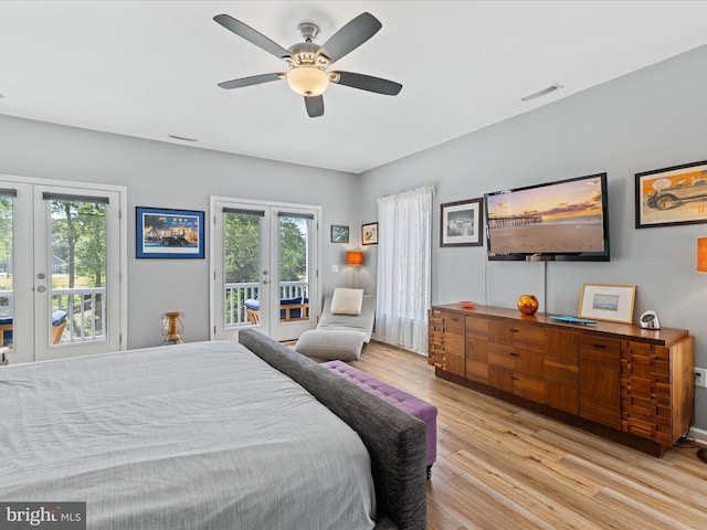 bedroom with french doors, access to exterior, multiple windows, and wood finished floors