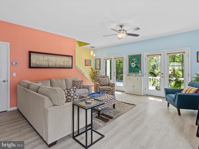 living room featuring light wood-style floors, ceiling fan, and french doors