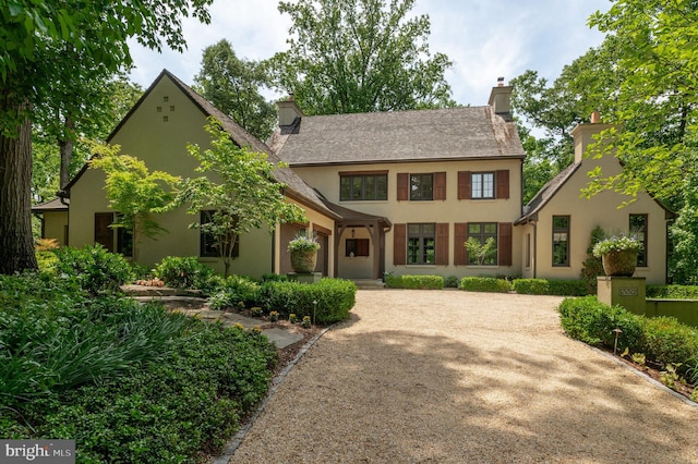 13312 Drews Ln, Potomac, MD 20854 - view of front of property featuring stucco siding, a chimney, and driveway