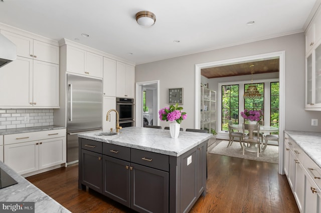 13312 Drews Ln, Potomac, MD 20854 - kitchen with stainless steel built in refrigerator, white cabinetry, dark wood-style flooring, backsplash, and crown molding