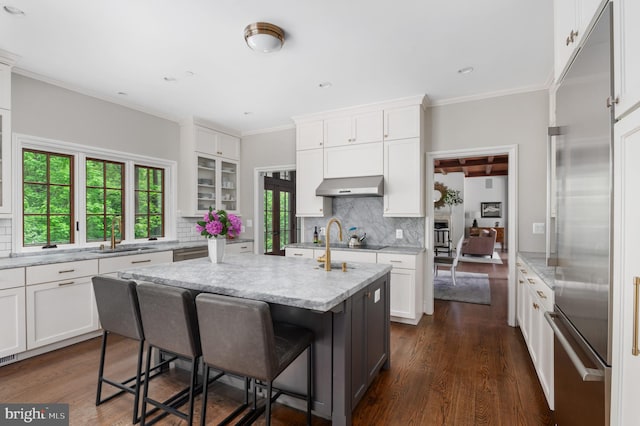 13312 Drews Ln, Potomac, MD 20854 - kitchen featuring built in fridge, ventilation hood, a sink, decorative backsplash, and white cabinets
