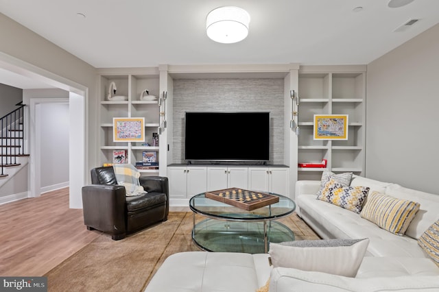 13312 Drews Ln, Potomac, MD 20854 - living room with built in shelves, stairs, wood finished floors, and baseboards