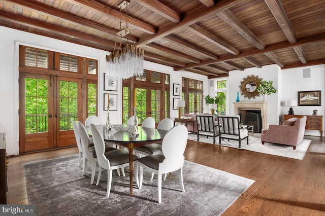 13312 Drews Ln, Potomac, MD 20854 - dining space with french doors, a fireplace, wood ceiling with exposed beams, and wood finished floors