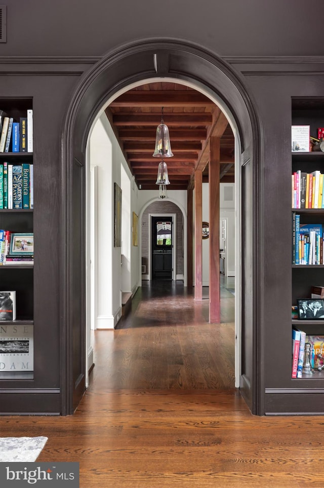13312 Drews Ln, Potomac, MD 20854 - hall with arched walkways, wood finished floors, and beamed ceiling