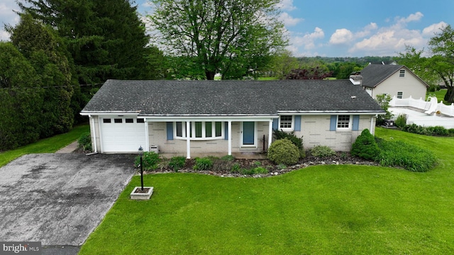 630 E Canal Rd, York, PA 17404 - view of front of house with driveway, an attached garage, brick siding, and a front yard