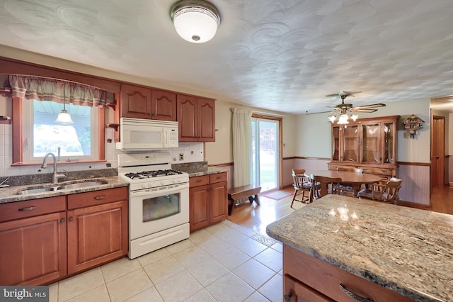630 E Canal Rd, York, PA 17404 - kitchen featuring white appliances, a sink, brown cabinets, stone counters, and light tile patterned floors