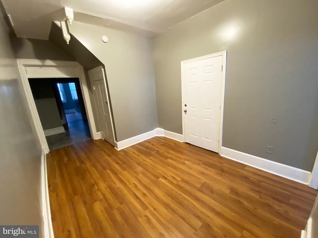 empty room featuring wood finished floors and baseboards