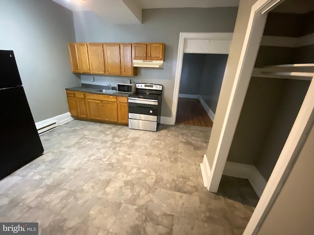 kitchen with stainless steel electric range, a sink, freestanding refrigerator, under cabinet range hood, and baseboards