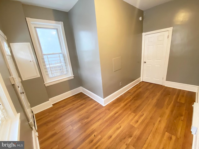 empty room featuring baseboards and light wood-style flooring
