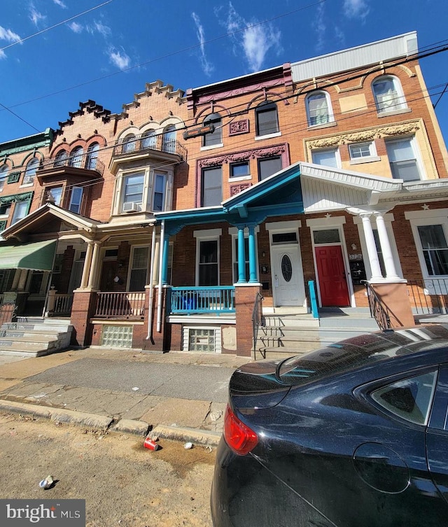 multi unit property with covered porch and brick siding