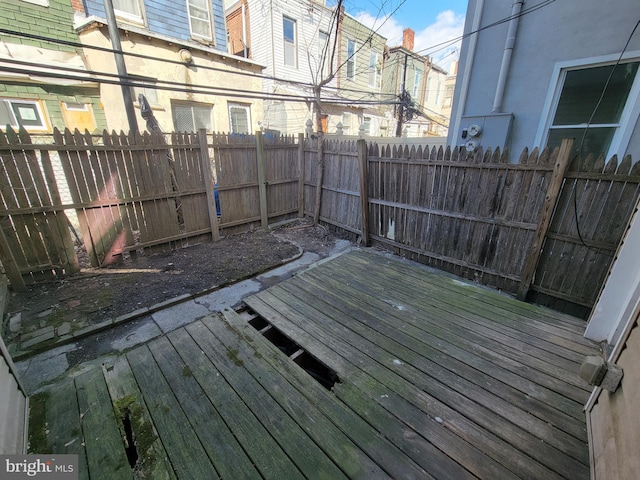 wooden terrace featuring a fenced backyard