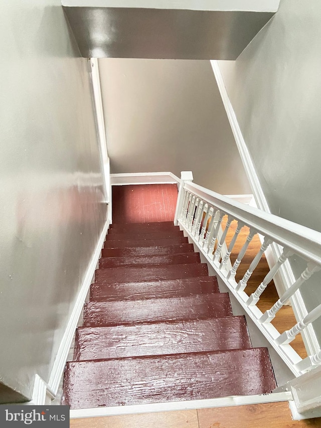stairway featuring baseboards
