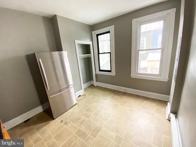unfurnished dining area with baseboards