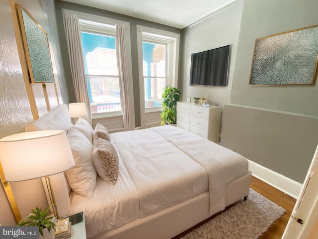 bedroom with wood finished floors and baseboards