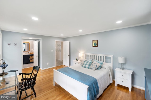 bedroom featuring light wood finished floors, recessed lighting, baseboards, and ensuite bathroom