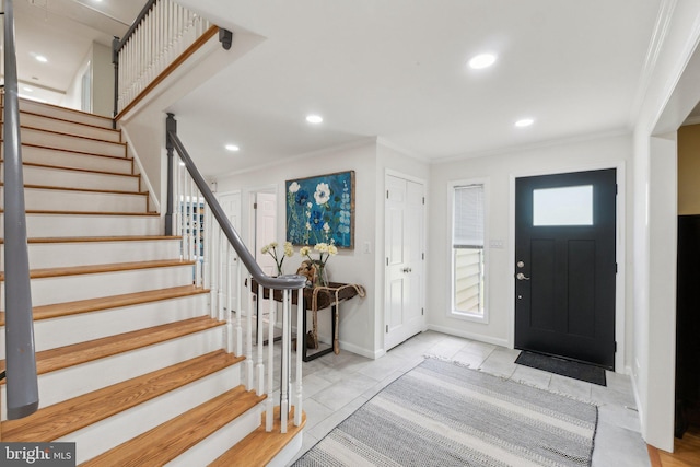 tiled entrance foyer featuring crown molding, stairs, recessed lighting, and baseboards