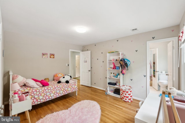 bedroom featuring light wood-style floors and baseboards