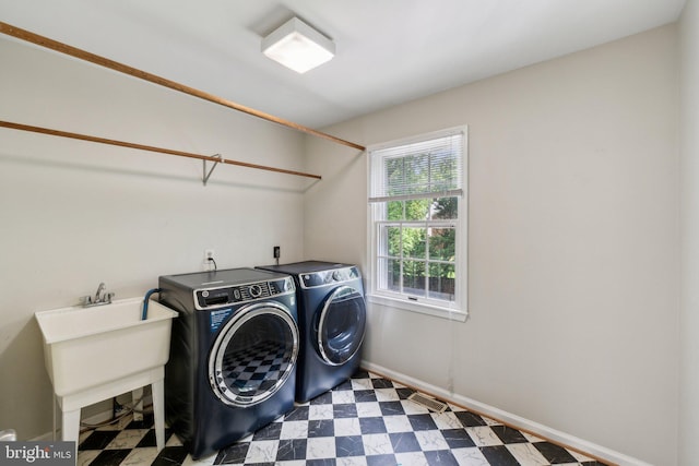 laundry area featuring washer and dryer, tile patterned floors, and baseboards