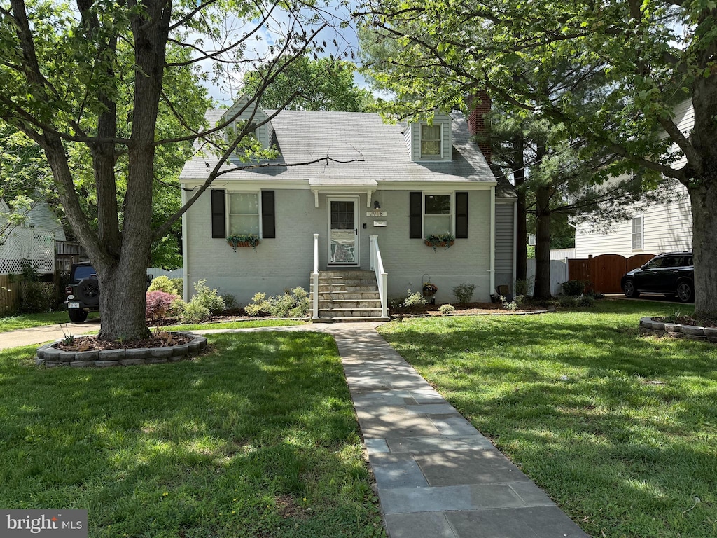 bungalow featuring a chimney and a shingled roof