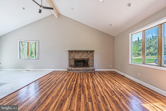 50 N Ave, Cedarville, NJ 08311 - unfurnished living room featuring high vaulted ceiling, beam ceiling, wood finished floors, ceiling fan, and a brick fireplace