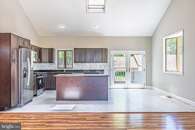 50 N Ave, Cedarville, NJ 08311 - kitchen with appliances with stainless steel finishes, vaulted ceiling, dark brown cabinets, tasteful backsplash, and a kitchen island