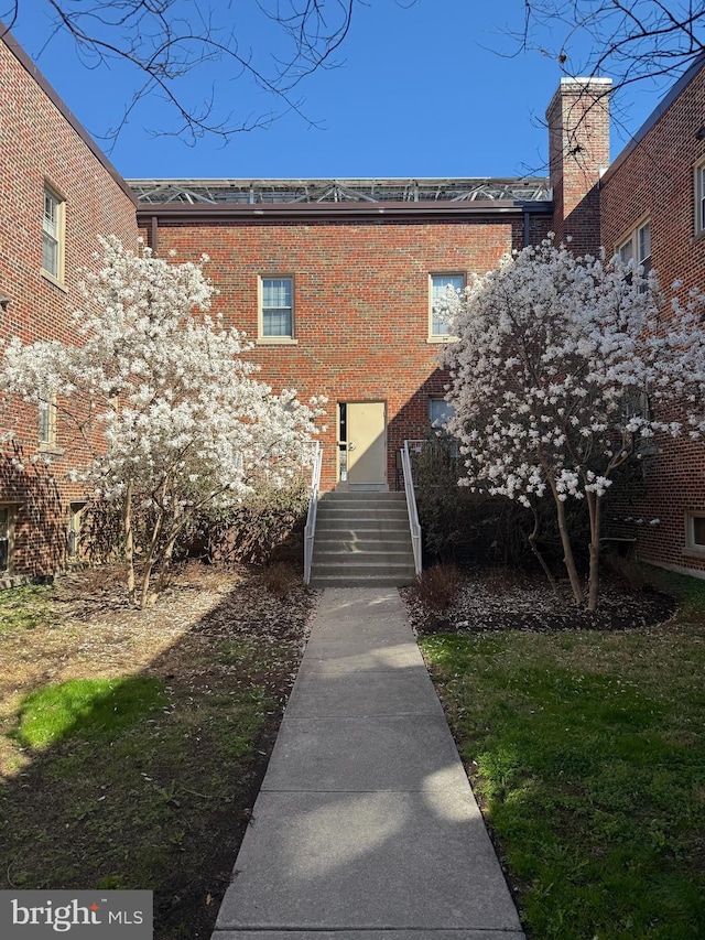 rear view of house with brick siding