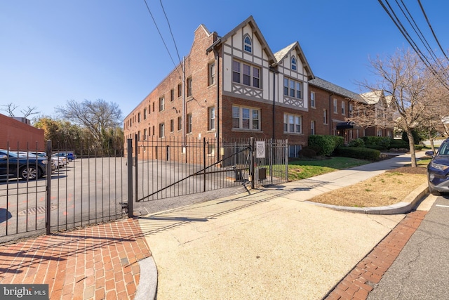 view of building exterior featuring a fenced front yard and a residential view