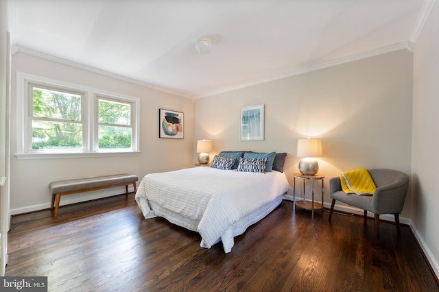 bedroom featuring ornamental molding, dark wood-style floors, and baseboards
