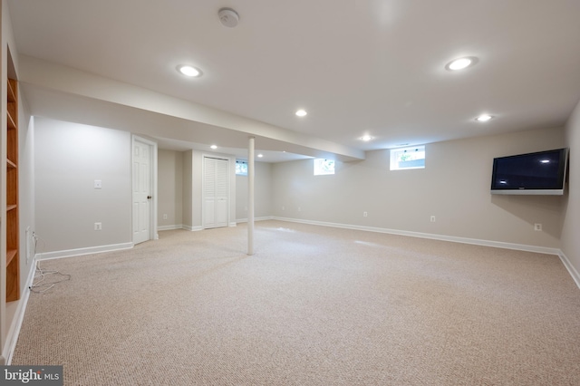 below grade area with light colored carpet, recessed lighting, and baseboards