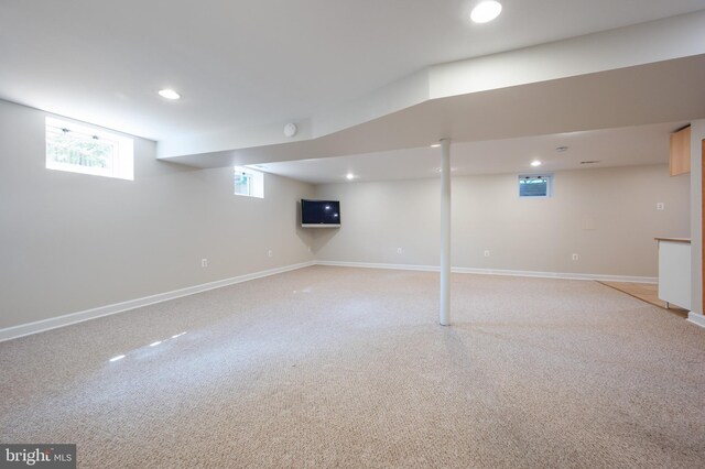below grade area with baseboards, recessed lighting, and light colored carpet