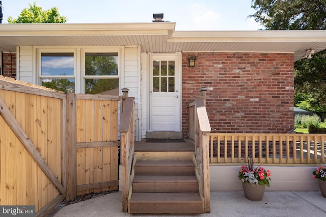 entrance to property featuring brick siding