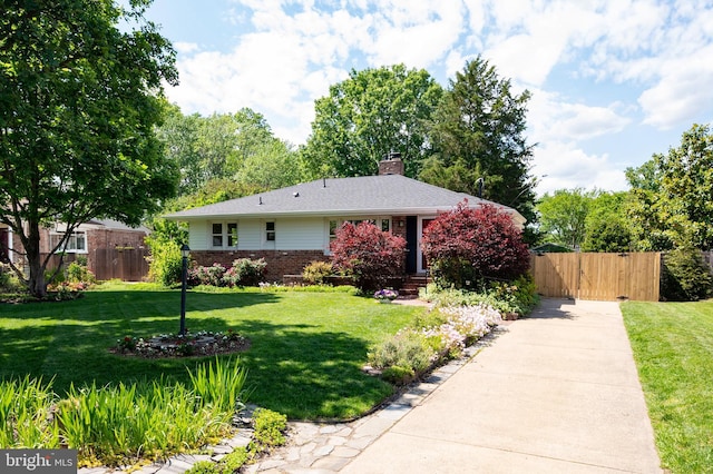 view of front of home with brick siding, a chimney, and a gate