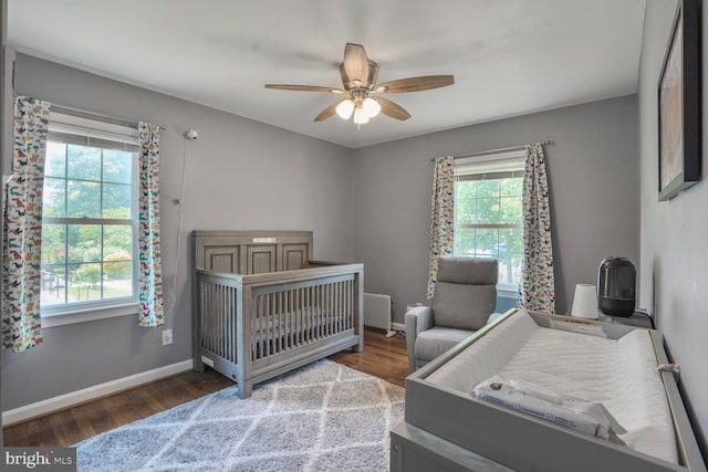 7039 Calamo St, Springfield, VA 22150 - bedroom featuring wood finished floors, baseboards, a nursery area, a ceiling fan, and a baseboard radiator
