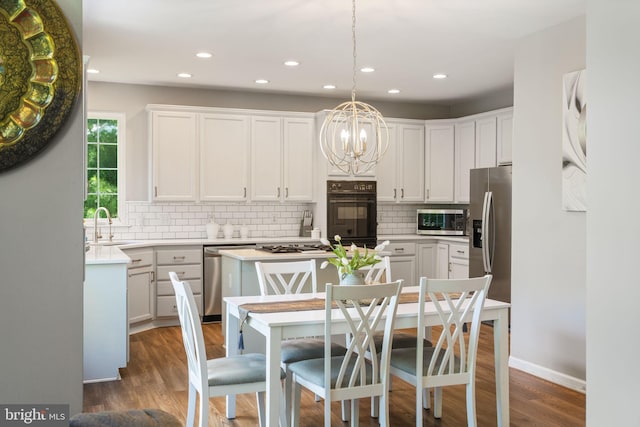 27 Avalon Rd, Pennington, NJ 08534 - kitchen featuring stainless steel appliances, a chandelier, decorative backsplash, a center island, and white cabinetry