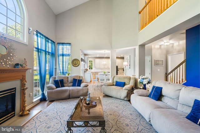 27 Avalon Rd, Pennington, NJ 08534 - living area with a towering ceiling, wood finished floors, stairway, and a glass covered fireplace