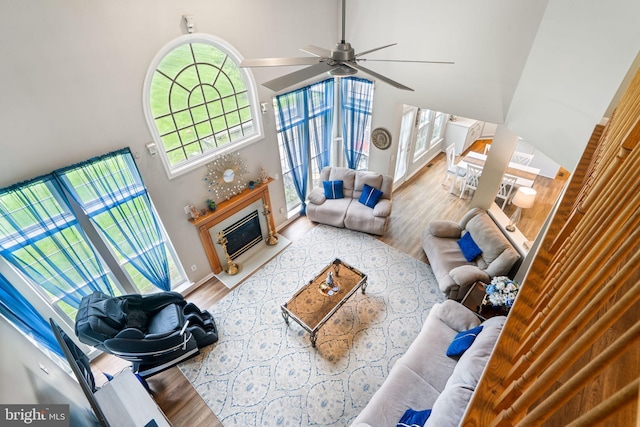 27 Avalon Rd, Pennington, NJ 08534 - living room featuring a high ceiling, wood finished floors, a glass covered fireplace, and a ceiling fan