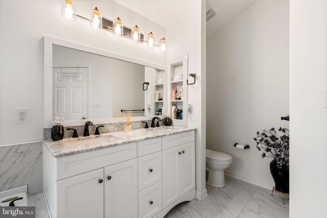 27 Avalon Rd, Pennington, NJ 08534 - bathroom with marble look tiles, toilet, and double vanity