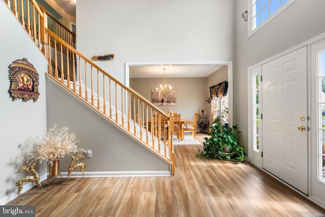 27 Avalon Rd, Pennington, NJ 08534 - entryway with a high ceiling, wood finished floors, a chandelier, stairs, and baseboards