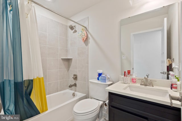 bathroom with shower / tub combo, toilet, and vanity