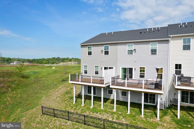 rear view of house featuring central AC unit and a deck