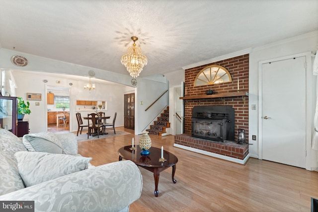 1517 Margaret St, Woodbridge, VA 22191 - living area with a chandelier, stairway, wood finished floors, a fireplace, and ornamental molding
