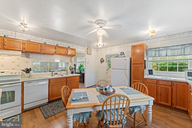 1517 Margaret St, Woodbridge, VA 22191 - kitchen featuring white appliances, under cabinet range hood, light countertops, light wood-style flooring, and ceiling fan