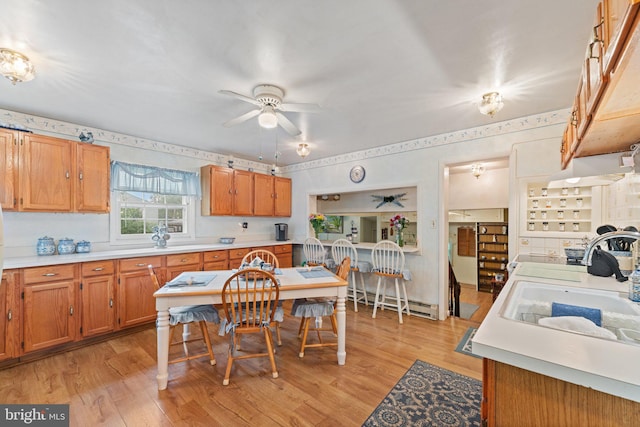 1517 Margaret St, Woodbridge, VA 22191 - kitchen with a baseboard radiator, light countertops, a ceiling fan, and light wood-type flooring