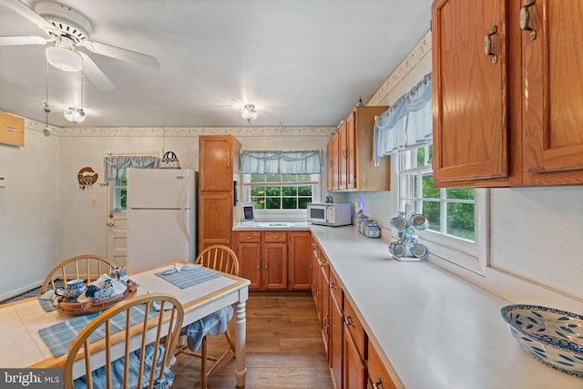 1517 Margaret St, Woodbridge, VA 22191 - kitchen featuring white appliances, brown cabinetry, light countertops, a ceiling fan, and wood finished floors