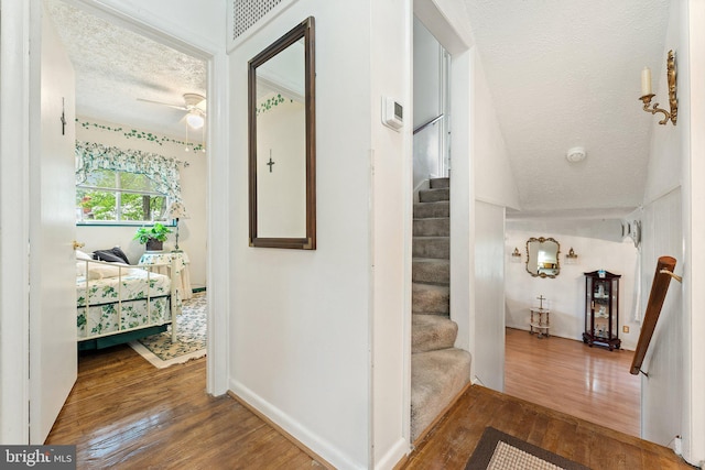 1517 Margaret St, Woodbridge, VA 22191 - hall with hardwood / wood-style floors, a textured ceiling, stairway, and baseboards