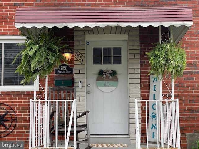 entrance to property with brick siding