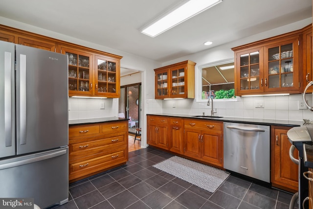 16 Lacosta Ct, Towson, MD 21204 - kitchen with stainless steel appliances, a sink, tasteful backsplash, brown cabinets, and glass insert cabinets