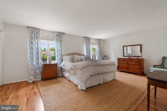 16 Lacosta Ct, Towson, MD 21204 - bedroom with multiple windows, light wood finished floors, and baseboards