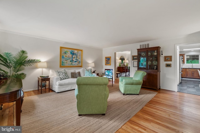 16 Lacosta Ct, Towson, MD 21204 - living area with light wood-style flooring and ornamental molding